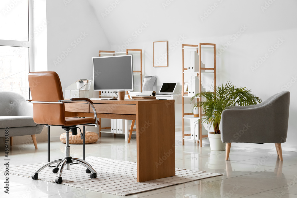 Workplace with modern computer in light office interior Workplace with modern computer in light office interior