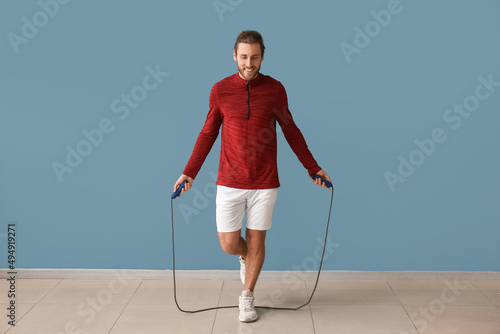 Sporty man jumping rope on ...