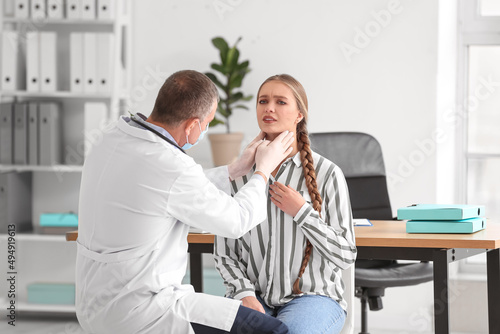 Doctor examining woman's ne...