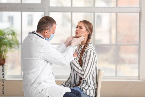 Doctor examining woman's ne...