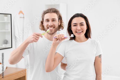 Lovely young couple brushin...
