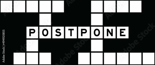 Alphabet letter in word postpone on crossword puzzle background