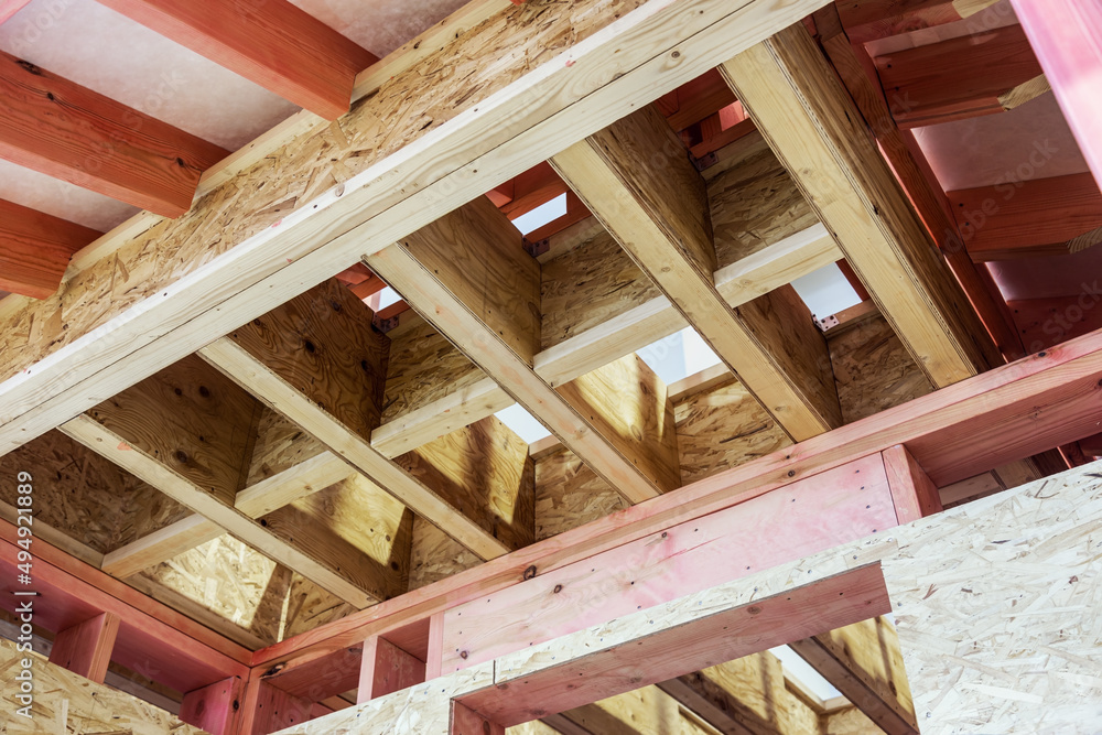 Installing attic insulation material and roof support truss system