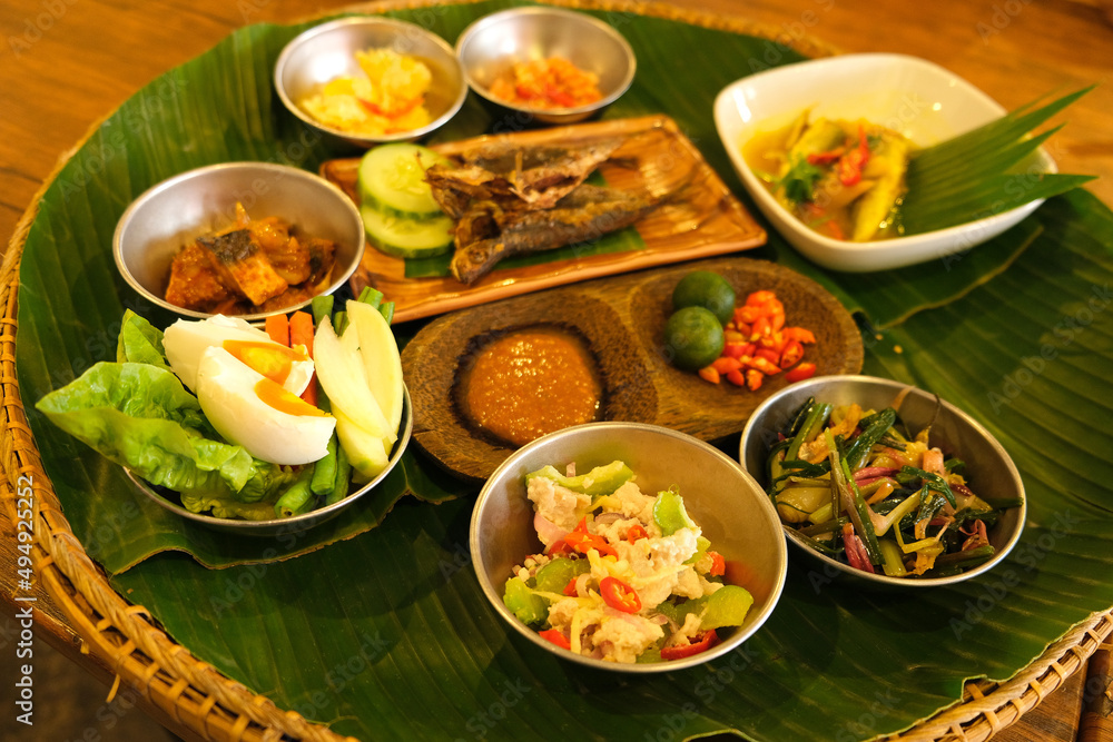 A complete ambuyat set with condiments, hinava, sambal, bamboo shoot ...