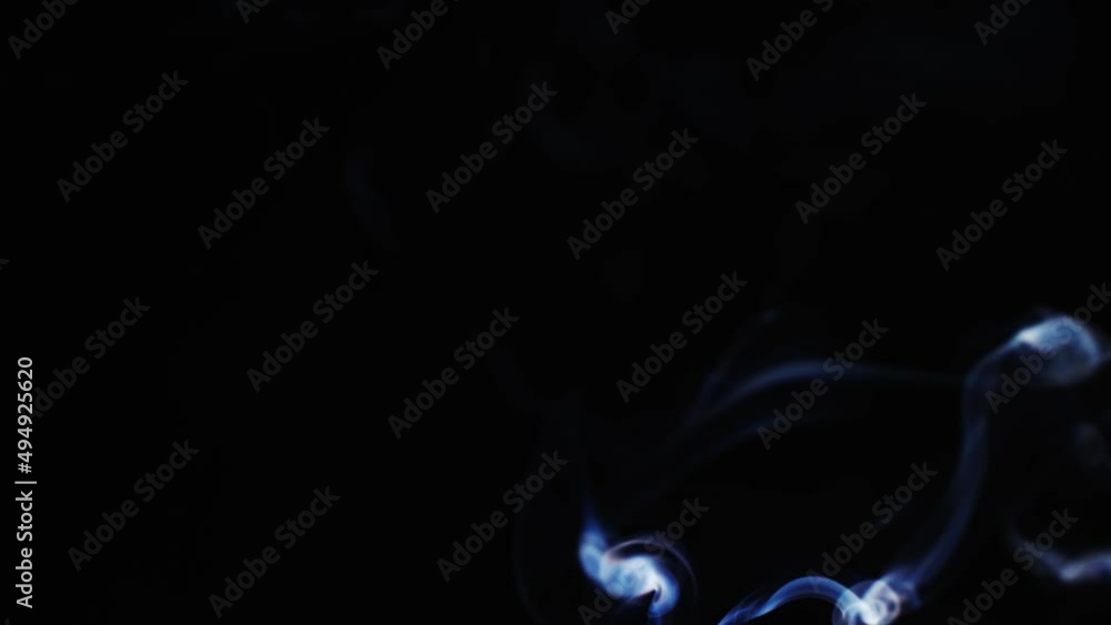 Abstract blue color smoke with a black background in slow motion. Realistic cloud smoke with streamline pattern. Abstract blue color smoke with a black background in slow motion. Realistic cloud smoke with streamline pattern.