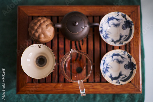 teapot and bowls prepared for the tea ceremony on a stand made of bamboo. view from above