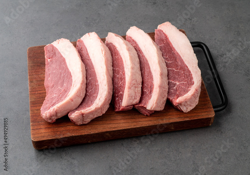 Sliced raw picanha or rump meat over wooden board