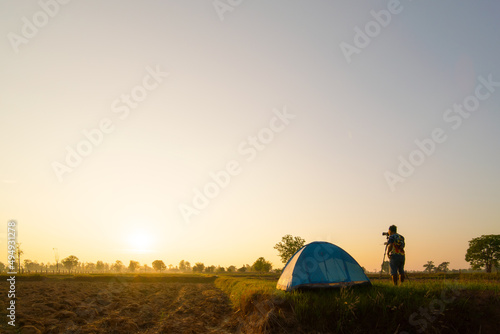tent on a field at sunset