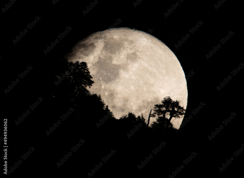 Fototapeta premium full moon over a Mountain