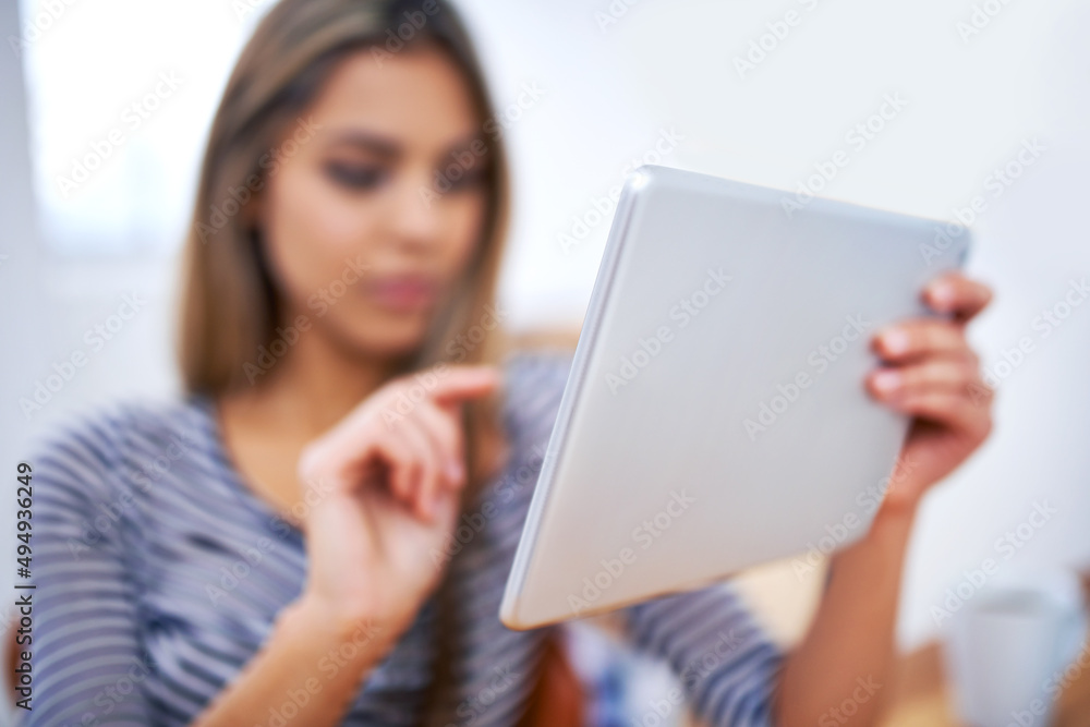 Every professional should have one. A cropped shot of a beautiful young professional using a tablet at her desk. Every professional should have one. A cropped shot of a beautiful young professional using a tablet at her desk.