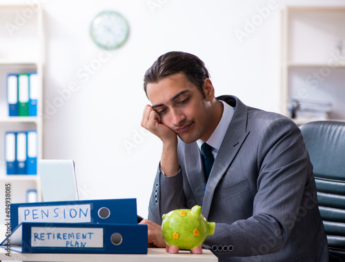 Young male accountant working in the office photo