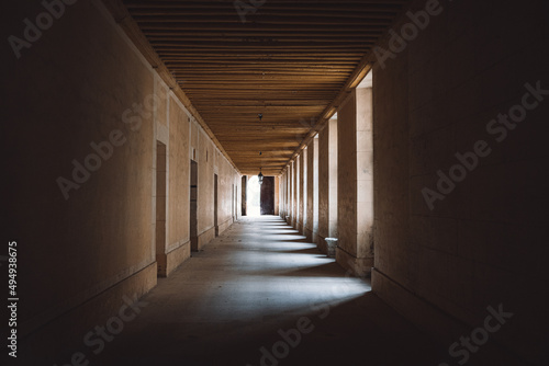 Closeup of a long hallway with lights between columns photo