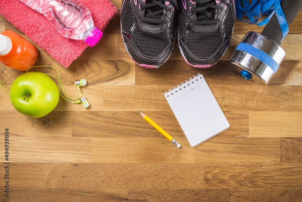 Sport, fitness workout objects and blank notebook for training schedules or record on wooden background. Health, sport and workout concept. Sport, fitness workout objects and blank notebook for training schedules or record on wooden background. Health, sport and workout concept.