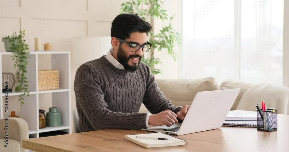 Businessman working on laptop and celebrating success at office Businessman working on laptop and celebrating success at office