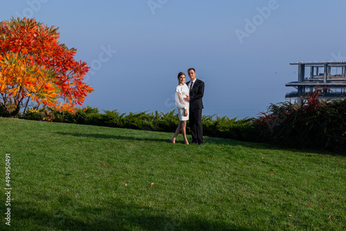Fototapeta Naklejka Na Ścianę i Meble -  Amazing smiling wedding couple. Satisfied bride and stylish groom. Autumn mood