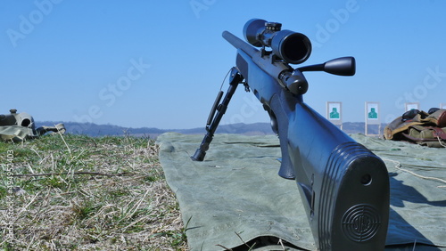 Modern powerful sniper rifle with telescopic view mounted on a bipod. Ammunition by rifle.