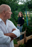 portrait of man in a wet shirt and woman standing outdoors