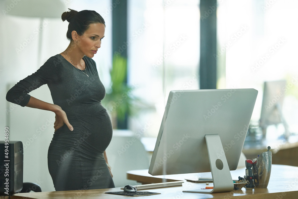 Tying together some loose ends before maternity leave. Shot of a pregnant businesswoman working in an office. - obrazy, fototapety, plakaty 