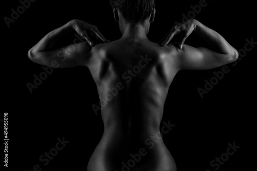 Black and white image of a beautiful female body. Studio shooting with backlight. Sexy body. healthy female body concept in black and white