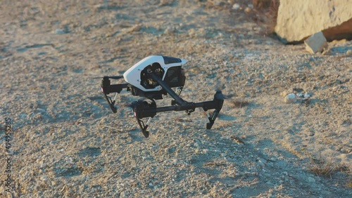 Drone starting fly on rock mountains. Modern technologies for shooting photos and videos from above. Golden hour