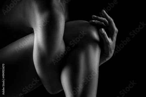 Black and white image of a beautiful female body. Studio shooting with backlight. Sexy body. healthy female body concept in black and white