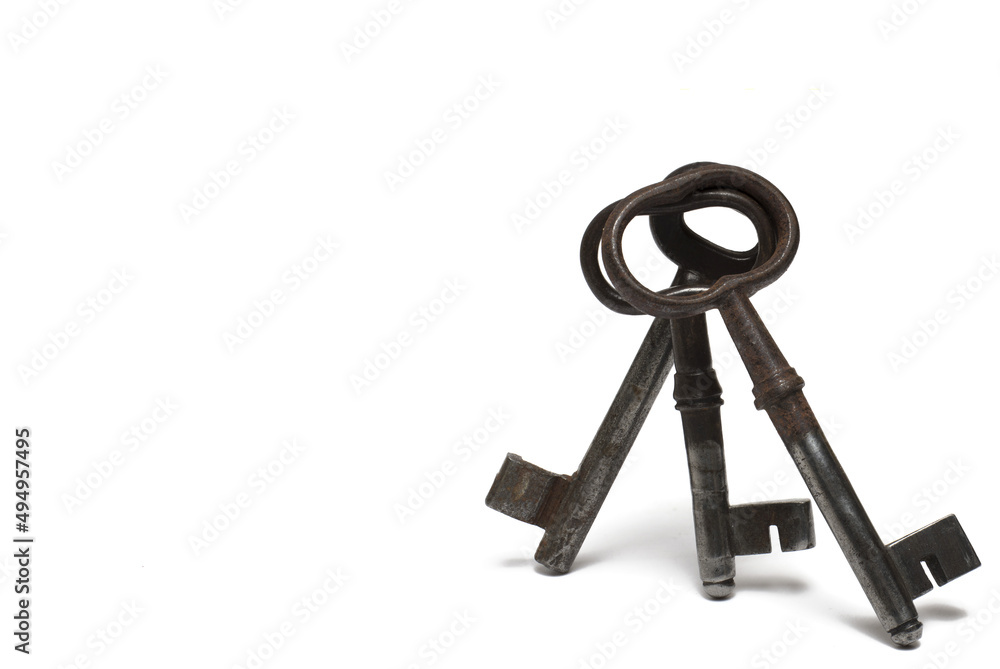 Closeup three old keys leaning white background Closeup three old keys leaning white background