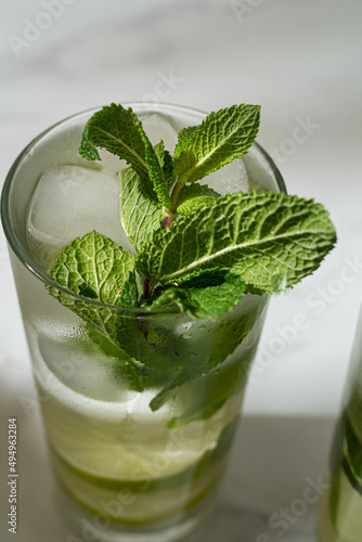 Close-up of mojito with ice, mint on the marble background. Refreshing, non-alcoholic summer cocktail.