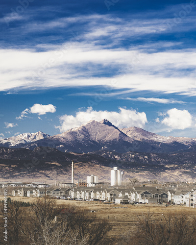 Vertical shot of the Sugar Mill in Longmont with rocky mountains in the background photo