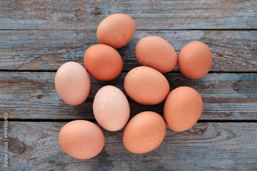 Brown beautiful eggs on a blue wooden background. Farm concept, diet product. Close-up