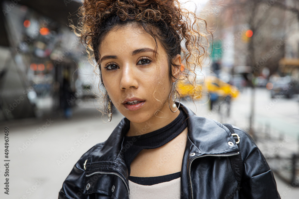 New York City lifestyle featuring young woman with curly hair wearing black leather jacket outside New York City lifestyle featuring young woman with curly hair wearing black leather jacket outside