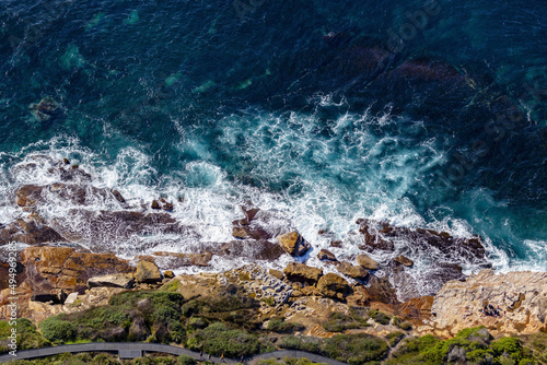Photography Aerial view of the wavy Tasmanian sea hitting the rocky cliffs on the coast