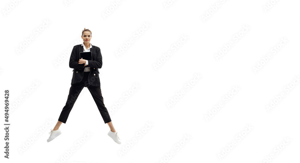 Dynamic portrait of young pretty girl wearing business style clothes jumping with folders isolated on white background. Dynamic portrait of young pretty girl wearing business style clothes jumping with folders isolated on white background.