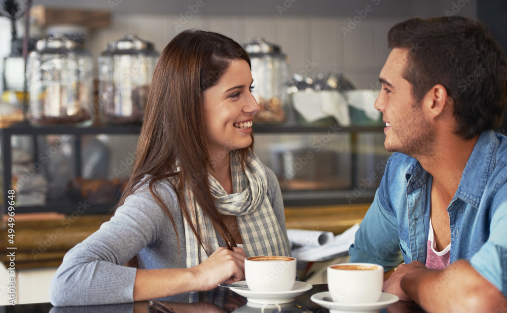 Having an intimate date. A loving young couple at a coffee shop together. Having an intimate date. A loving young couple at a coffee shop together.