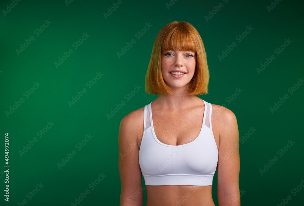 Commit to be fit. Cropped portrait of an attractive young sportswoman standing alone against a green background in the studio. Commit to be fit. Cropped portrait of an attractive young sportswoman standing alone against a green background in the studio.