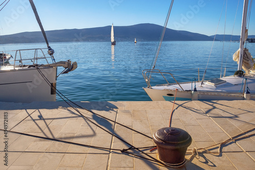 Beautiful Mediterranean landscape. Montenegro, Kotor Bay. Embankment of Tivat city, sailing boats on the water