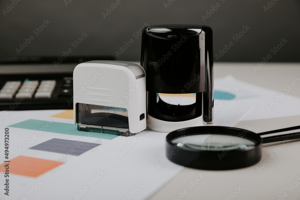 Office desktop with documentsm magnifier and stamp close-up Office desktop with documentsm magnifier and stamp close-up