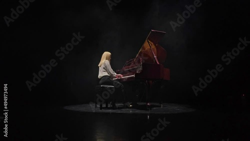 Woman playing classical piano concerto