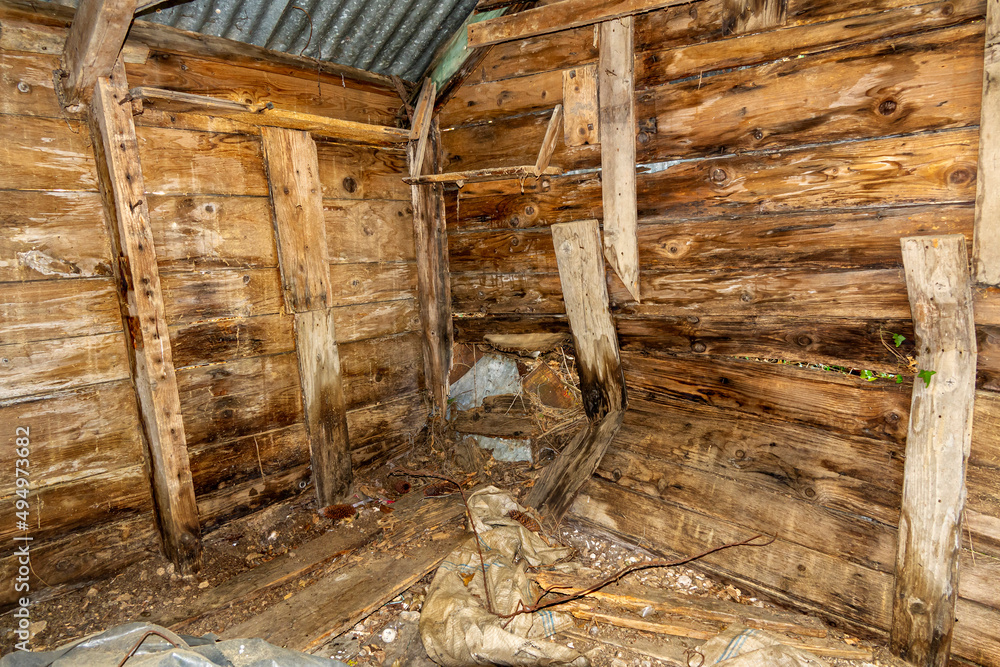 interior of old wooden shack, dilapidated ancient interior of old wooden shack, dilapidated ancient