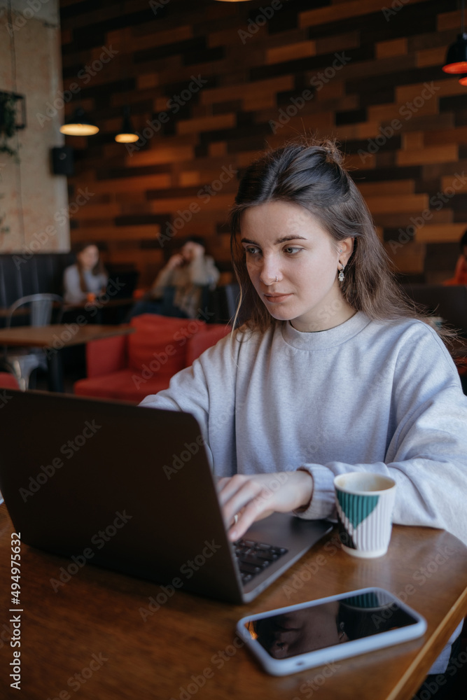 freelance woman happy working in a cafe remotely