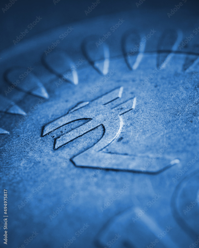 Translation: rupee. Fragment of Indian 10 rupee coin with the sign of the national currency close-up. Blue tinted illustration with vignettig. Economy and finance of India. Vertical stories. Macro Translation: rupee. Fragment of Indian 10 rupee coin with the sign of the national currency close-up. Blue tinted illustration with vignettig. Economy and finance of India. Vertical stories. Macro