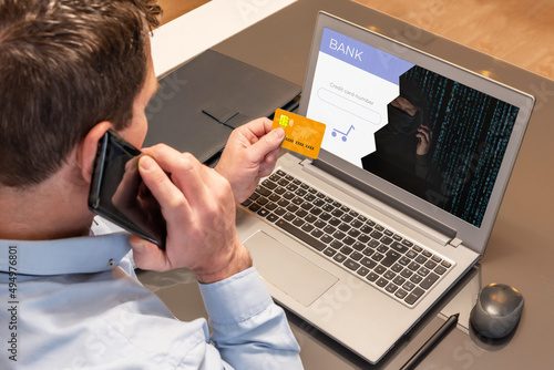 Man making purchases with his credit card over the phone while being scammed by a cyber thief. Vishing scam