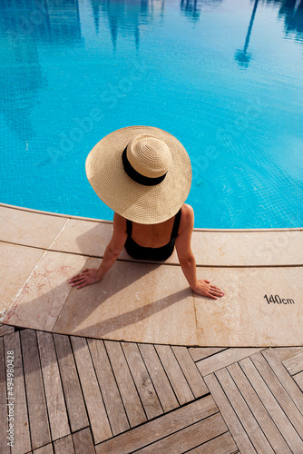 Beautiful woman sunbathing by the pool top view horizontal. Summer background. Poster, mock up for design photo