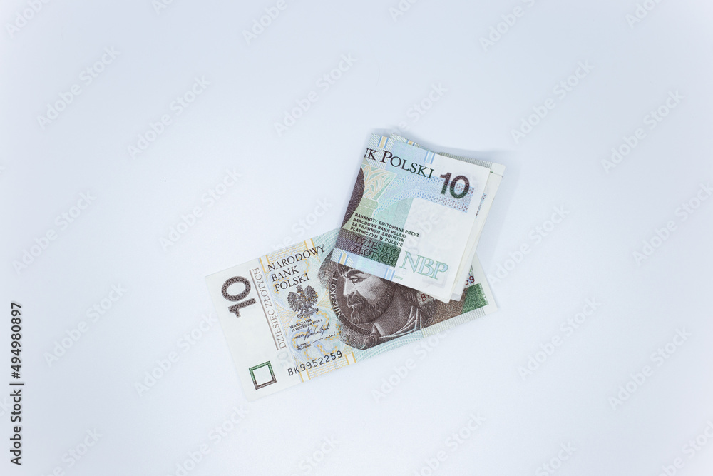 Zloty - Polish banknote. Polish currency on a white background arranged in a pattern. Illustrates cash flow and business Zloty - Polish banknote. Polish currency on a white background arranged in a pattern. Illustrates cash flow and business