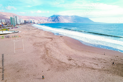 Landscape of a beach surrounded by the sea and buildings in Iquique, Chile photo