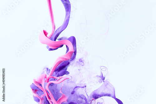 Paint splash abstract background. Acrylic ink drops. Pink and purple colors © Nik_Merkulov