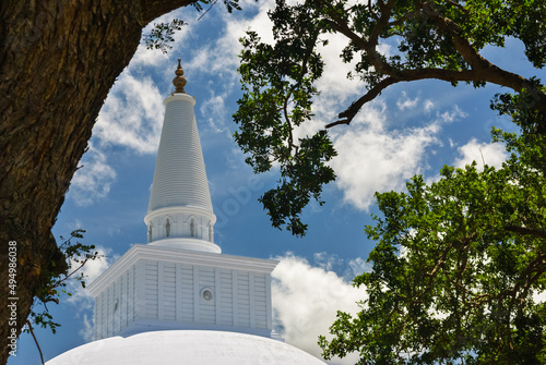 Ruwanwelisaya maha stupa, buddhist monument seen through trees, Anuradhapura, Sri Lanka photo