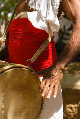 Traditionally dressed Sri Lankan drummer playing drum