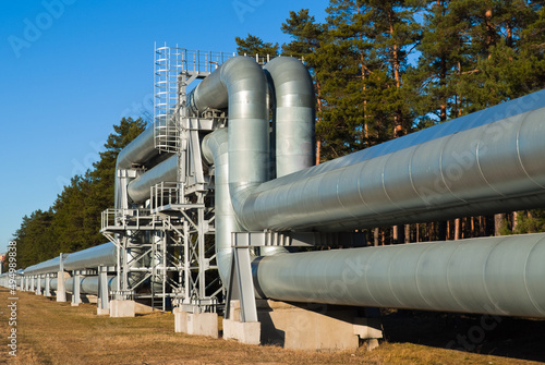 Photos pipeline, in the photo pipeline close-up against a background of green forest and blue sky