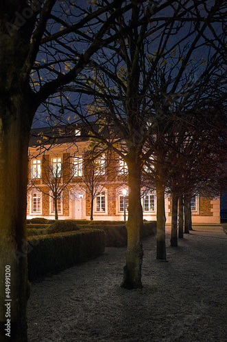 Vertical shot of the side wing of the Grandhotel Schloss Bensberg, Germany at night photo