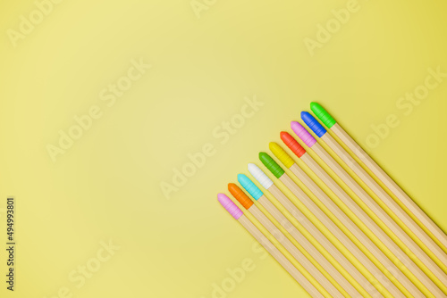3d illustrations of colored pencils on yellow background © Hector